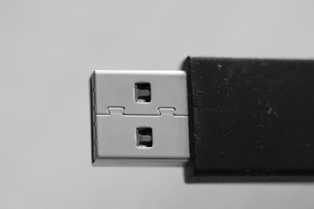 a close-up of a switch digital signature token, plugged USB device, tax filing on computer