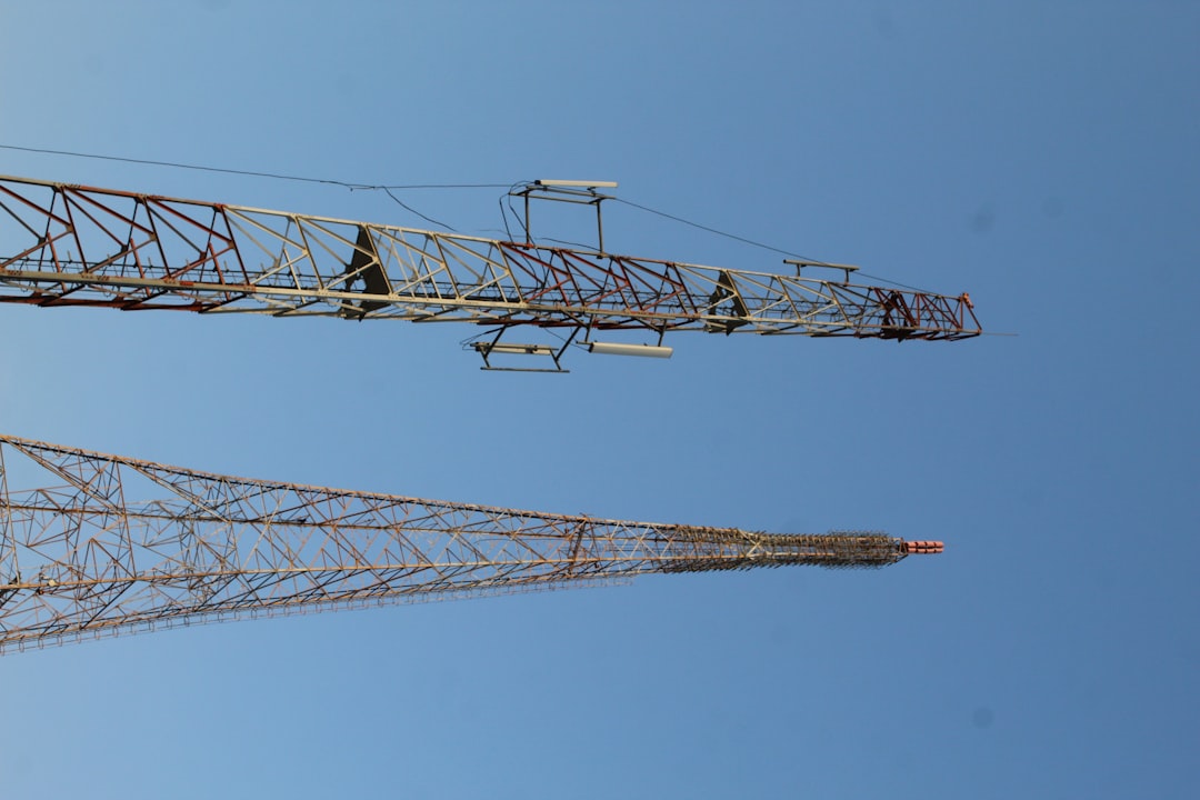 a couple of tall towers large construction site aerial view, cranes and scaffolding, project planning overlay
