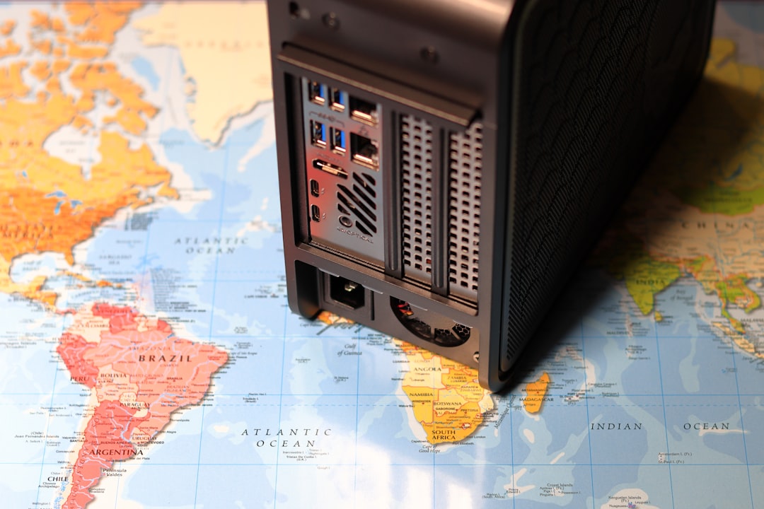 a desktop computer sitting on top of a map global server map, edge computing nodes, cloud infrastructure globe