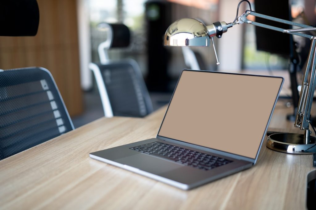 a laptop computer sitting on top of a wooden desk business owner reviewing supplier options on laptop, ecommerce planning workspace, product sourcing strategy