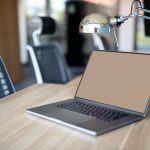 a laptop computer sitting on top of a wooden desk business owner reviewing supplier options on laptop, ecommerce planning workspace, product sourcing strategy