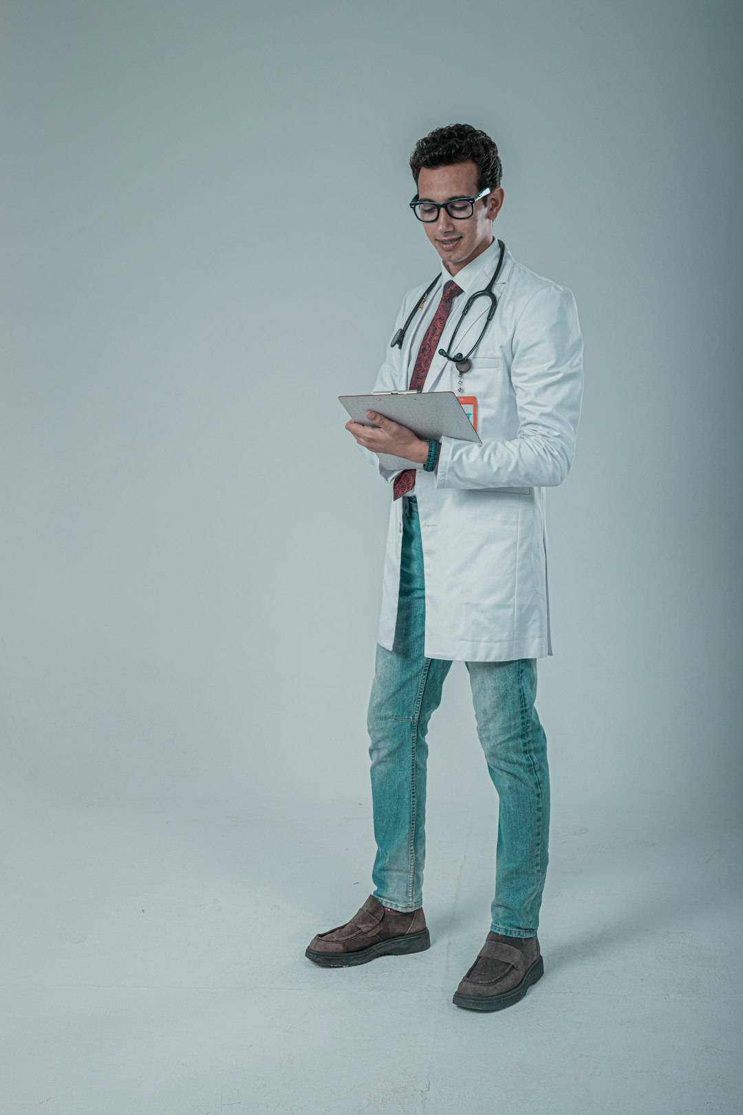 a male doctor in a white coat and tie doctor dictation, medical chart, clinic computer
