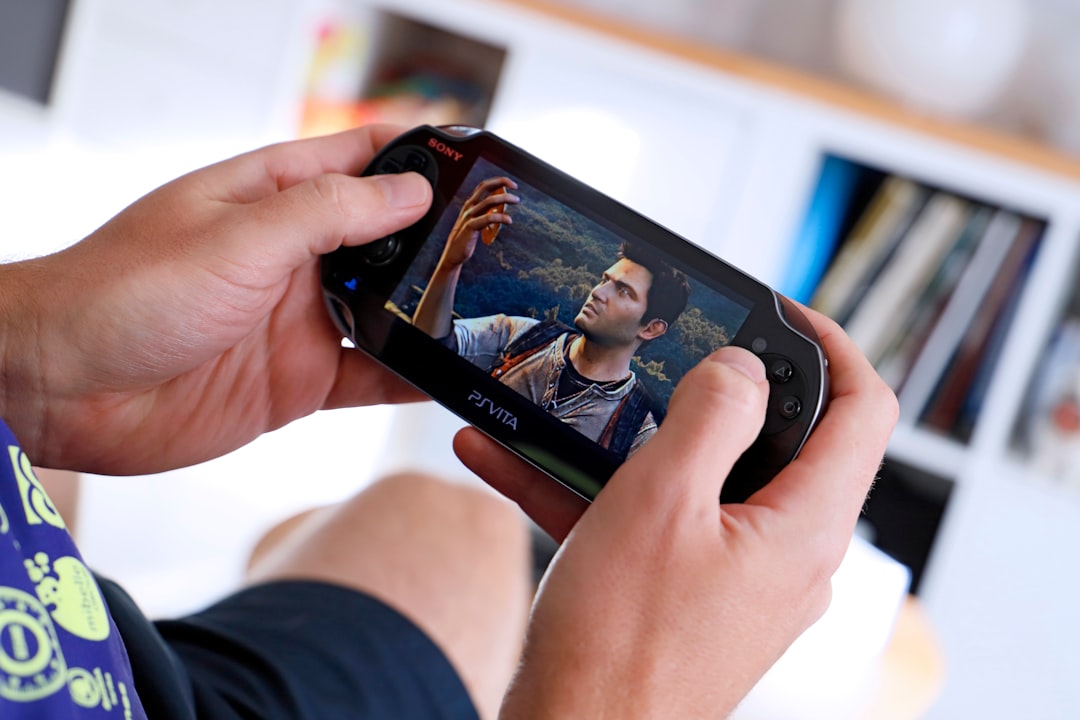 a man holding a smart phone up to his face handheld console gaming screen, high resolution gameplay, vivid graphics display