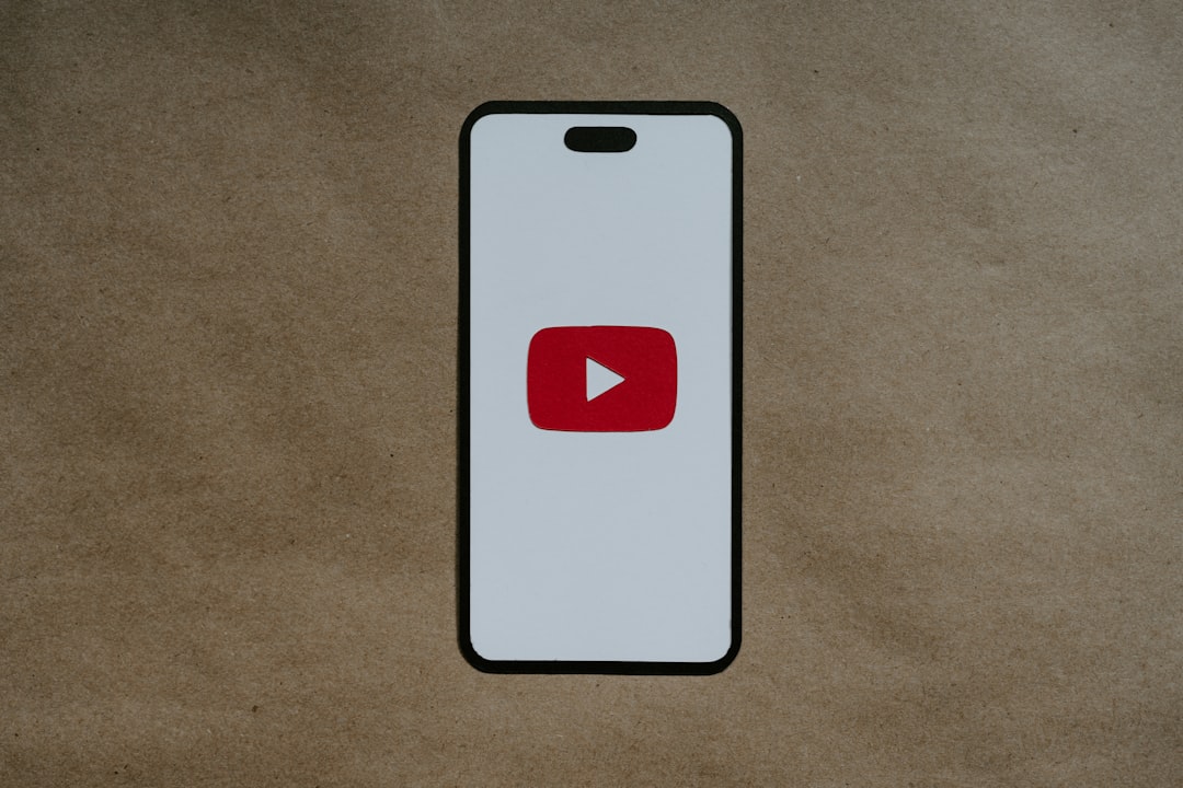 a white phone with a red youtube logo on it person editing video on smartphone frustrated notification pop up
