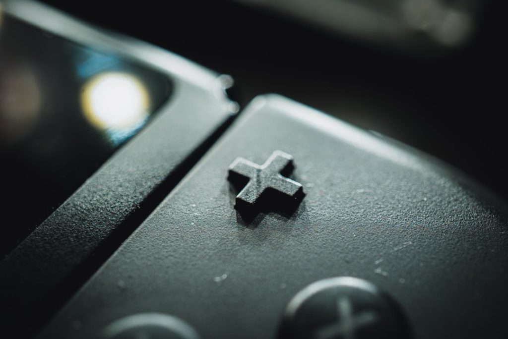 black and gray game controller nintendo switch game cartridges, game card slot, handheld console close up