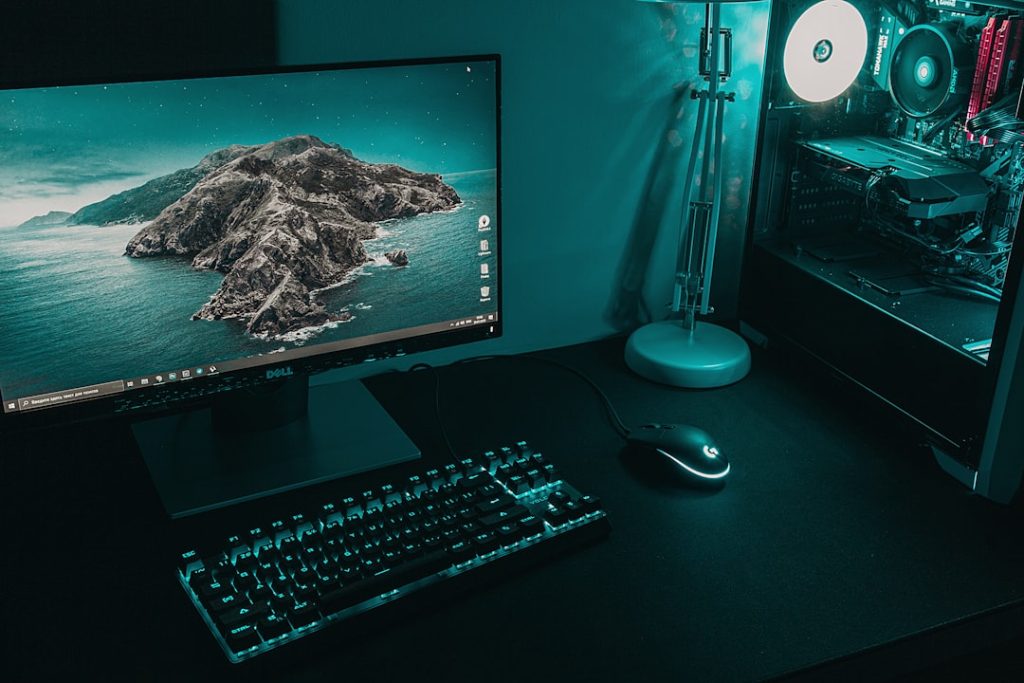 black flat screen computer monitor beside black computer keyboard gaming pc setup, blue screen error, gamer desk