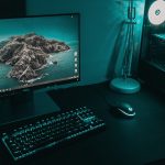 black flat screen computer monitor beside black computer keyboard gaming pc setup, blue screen error, gamer desk