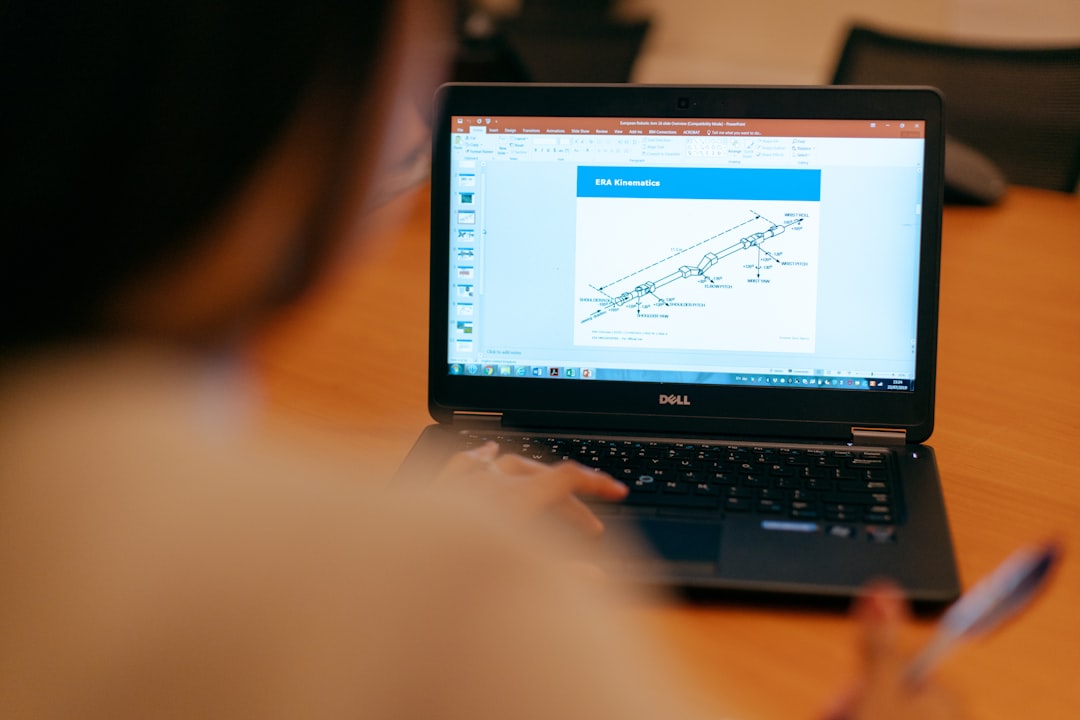 black laptop computer turned on on brown wooden table automated workflow diagram laptop screen business process