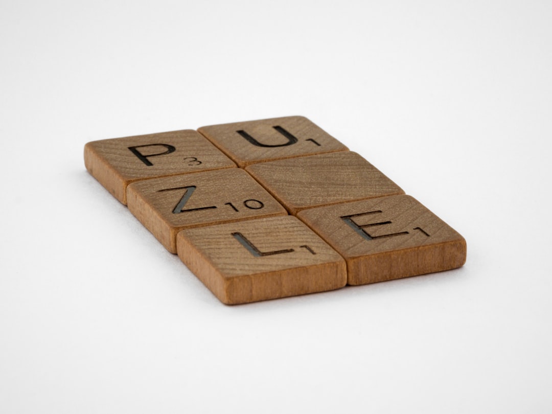 brown wooden blocks on white surface player thinking, phone puzzle, word strategy