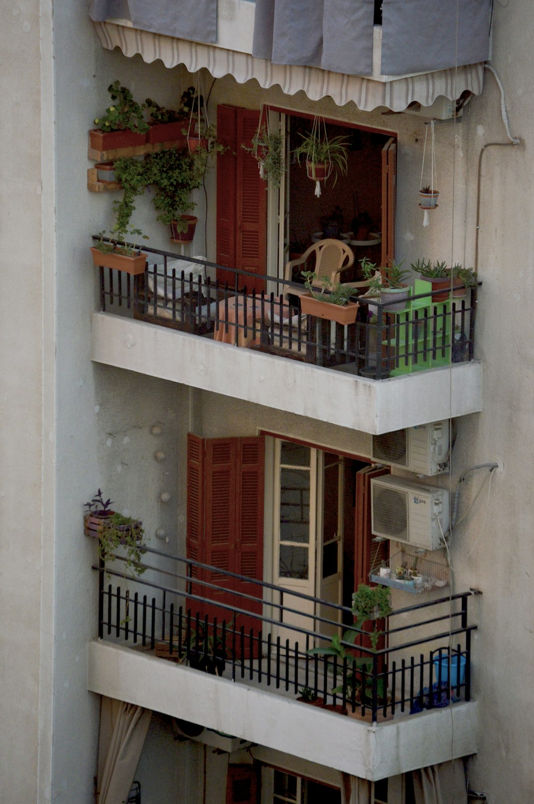 brown wooden window frame on white concrete wall cozy balcony with outdoor rug, string lights patio, modern outdoor seating