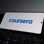 Coursera logo on a smartphone screen. corporate training dashboard, online learning interface, employee course platform