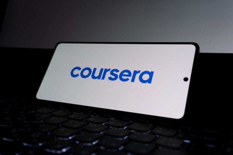Coursera logo on a smartphone screen. corporate training dashboard, online learning interface, employee course platform