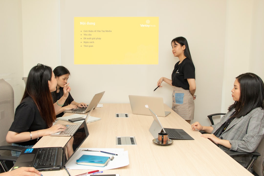 four women inside room business team training session, digital learning system, office collaboration technology