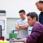 man in maroon long sleeve shirt holding a book enterprise automation software, cloud integration, team collaboration tools