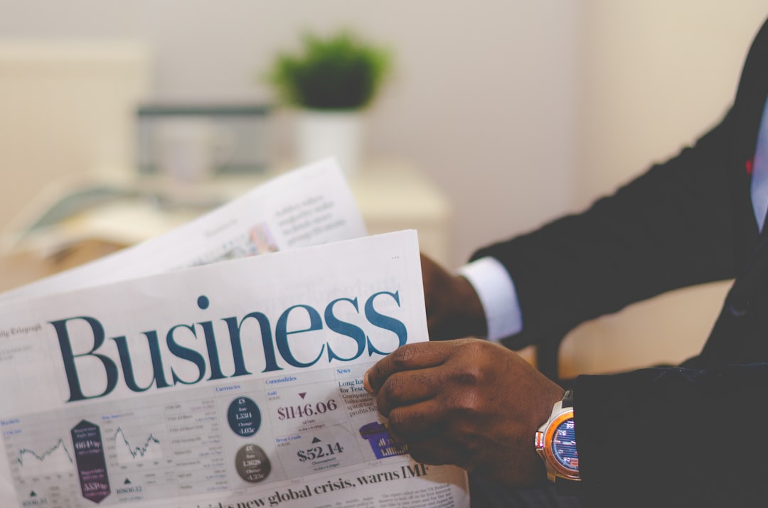 person wearing suit reading business newspaper business growth, competitive advantage, digital strategy