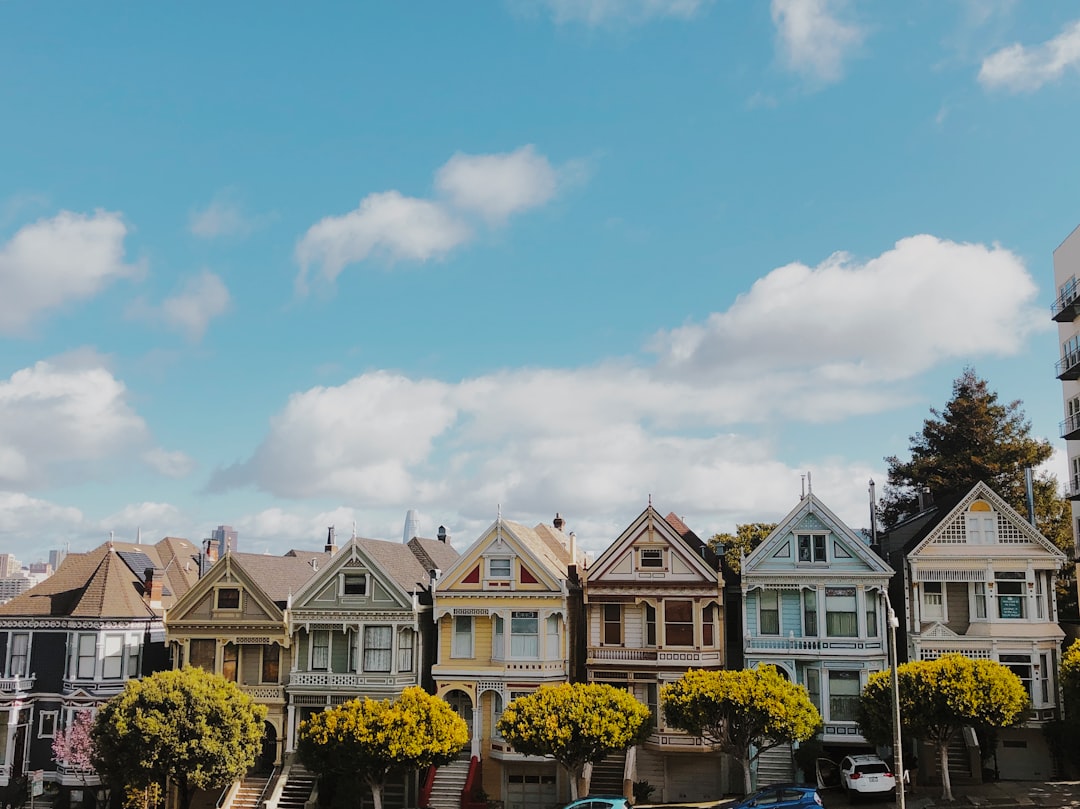 plants and vehicles near houses Airbnb founders apartment concept, short term rental home, San Francisco city houses