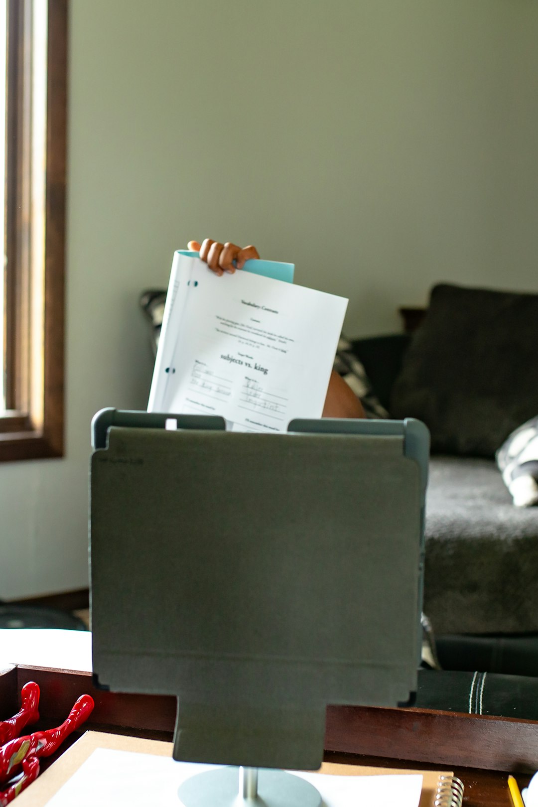 white printer paper on black table insurance claim documents, laptop with inventory report, house damage background