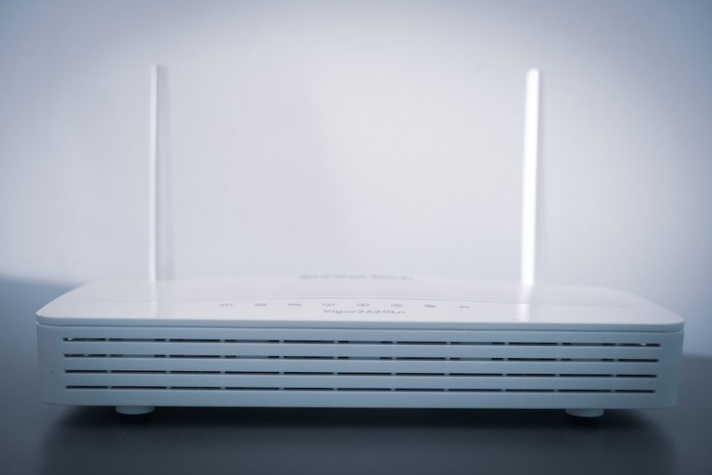 white router on black table wifi router restart, dns settings screen, smartphone network reset option
