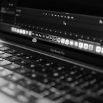 a black and white photo of a laptop old laptop editing photo, simple editing software interface, low end computer workspace