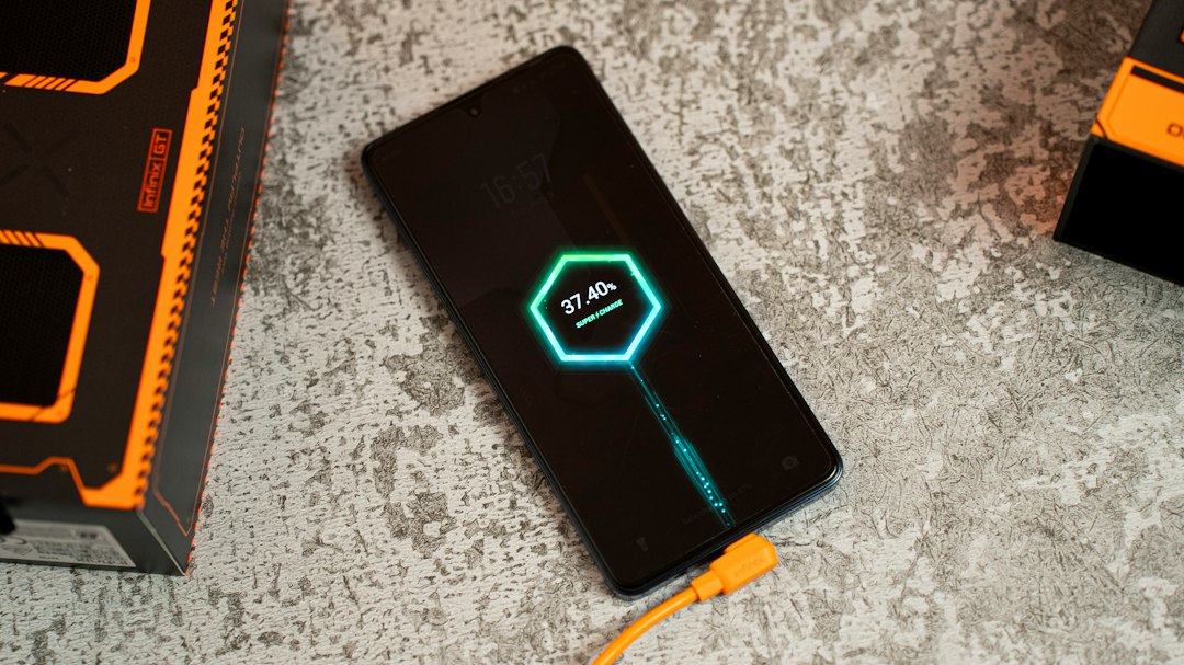 a black cell phone with a neon light on it rocket league loading screen error, game server outage screen, player checking server status on phone