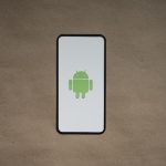 a cell phone with a green icon on it smartphone privacy, android apps, data tracking