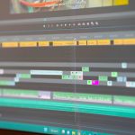 a close up of a computer screen with a keyboard video editing interface, subtitle timeline, transcription software screen