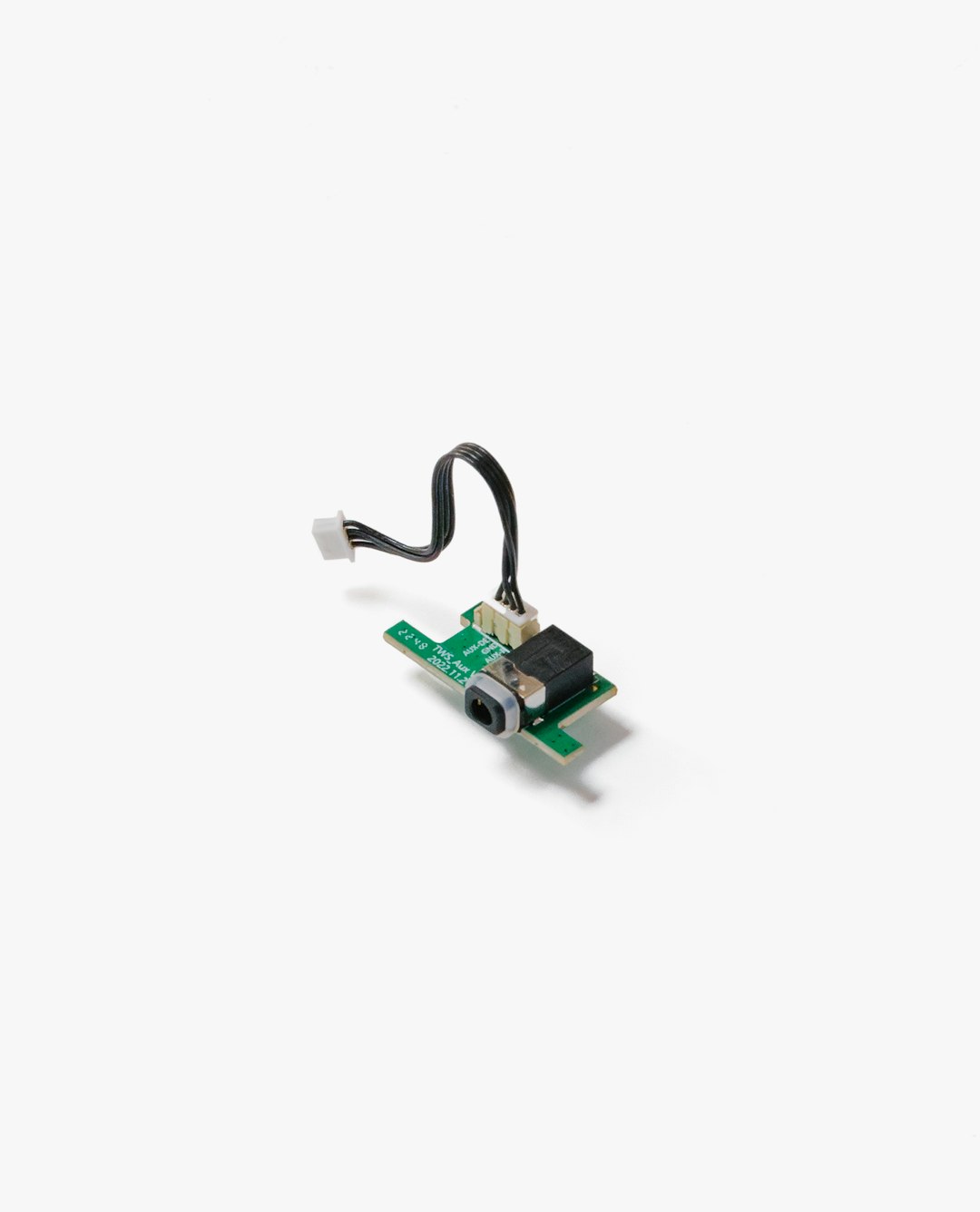 a close up of a piece of electronics on a white surface computer mouse internal components, scroll wheel encoder, small circuit board