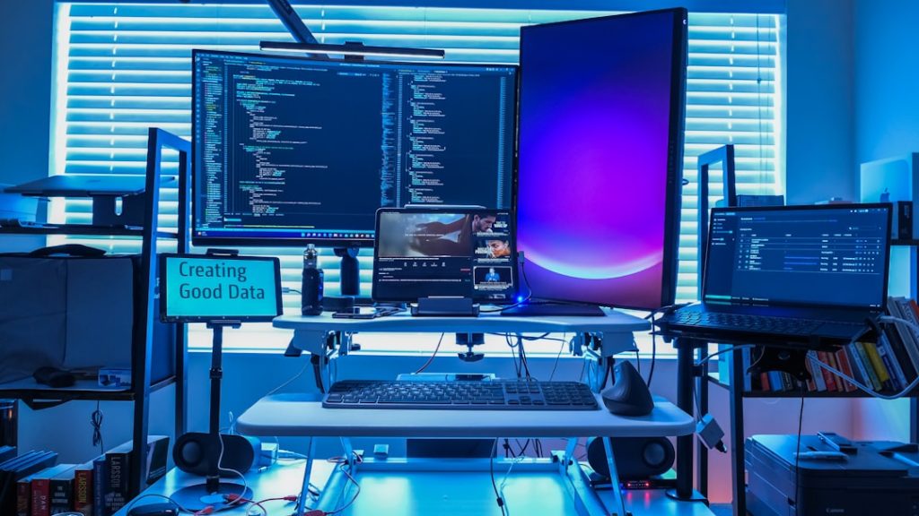 a desk with several computers digital forensics workstation, cybersecurity analyst, multiple monitors, data analysis