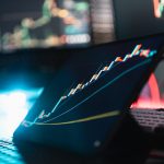 A laptop computer sitting on top of a desk dashboard analytics graphs subscription revenue chart laptop screen