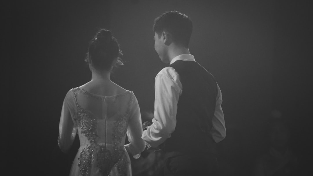 a man and a woman standing next to each other 1980s rock musician couple, backstage concert scene, vintage wedding style