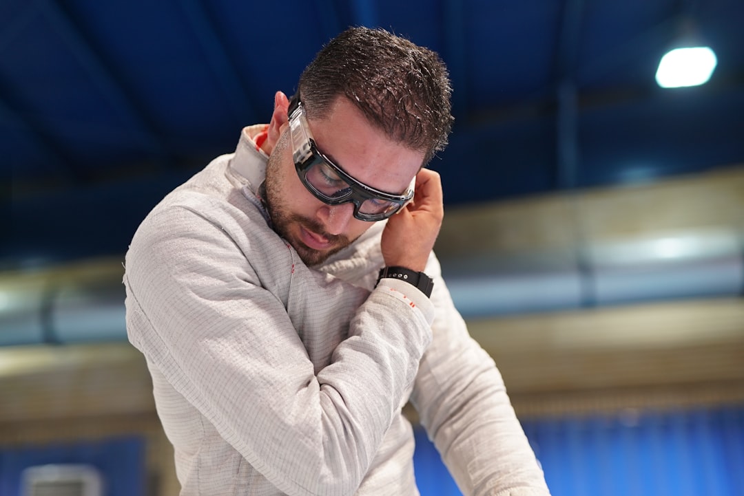 a man in a white sweater and goggles smart glasses display overlay, augmented reality instructions, industrial worker hands free