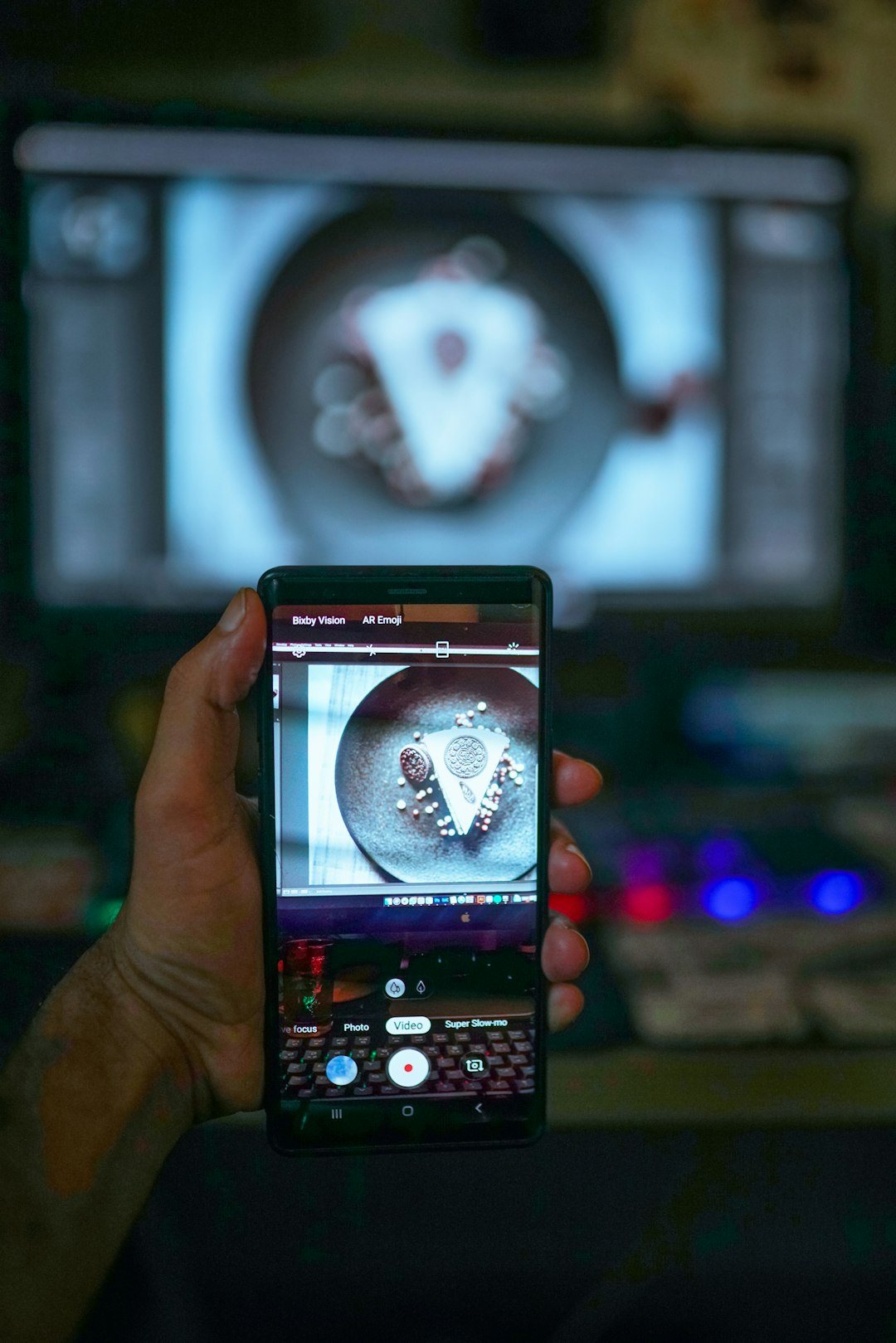 a person holding a cell phone in front of a tv vertical video editing mobile screen captions overlay