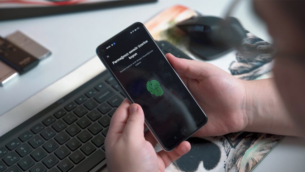 a person holding a phone person using tor browser on smartphone, privacy shield icon, secure browsing app interface, modern mobile screen