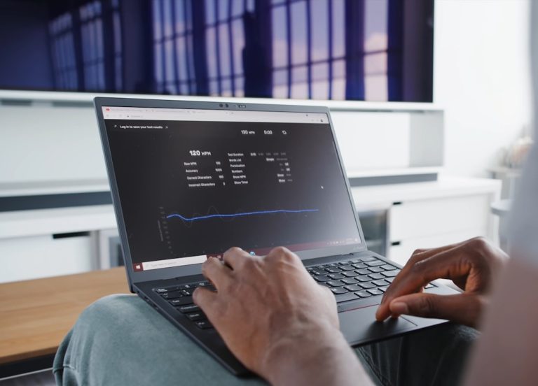 a person sitting in front of a laptop computer dashboard analytics graphs subscription revenue chart laptop screen