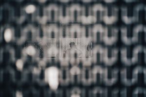 black and white checked textile cyber security lock icon, encrypted data screen, digital shield protection