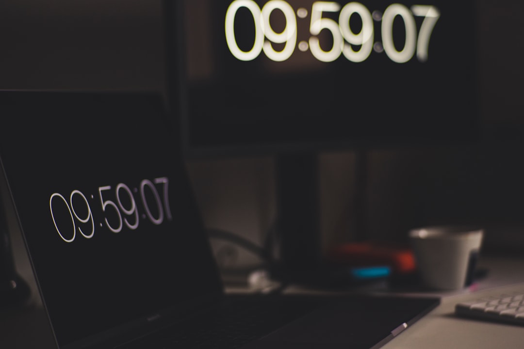 black laptop computer showing 9:59:07 calendar reminder, clock, laptop email notification