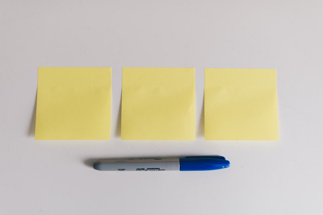 blue sharpie beside yellow sticky notes product idea, market research, sticky notes