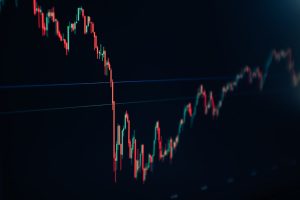 candlestick stock chart on dark screen trader analyzing stock charts, technical indicators, candlestick graph, smartphone trading