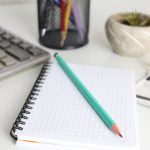 Desk with calculator, notebook, pencil, and plant. financial planning desk, calculator notebook, savings growth chart