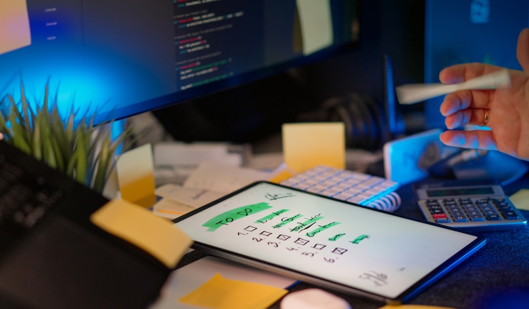 Developer working on multiple screens in a dark office. organized digital dashboard, legal case timeline screen, productivity workspace