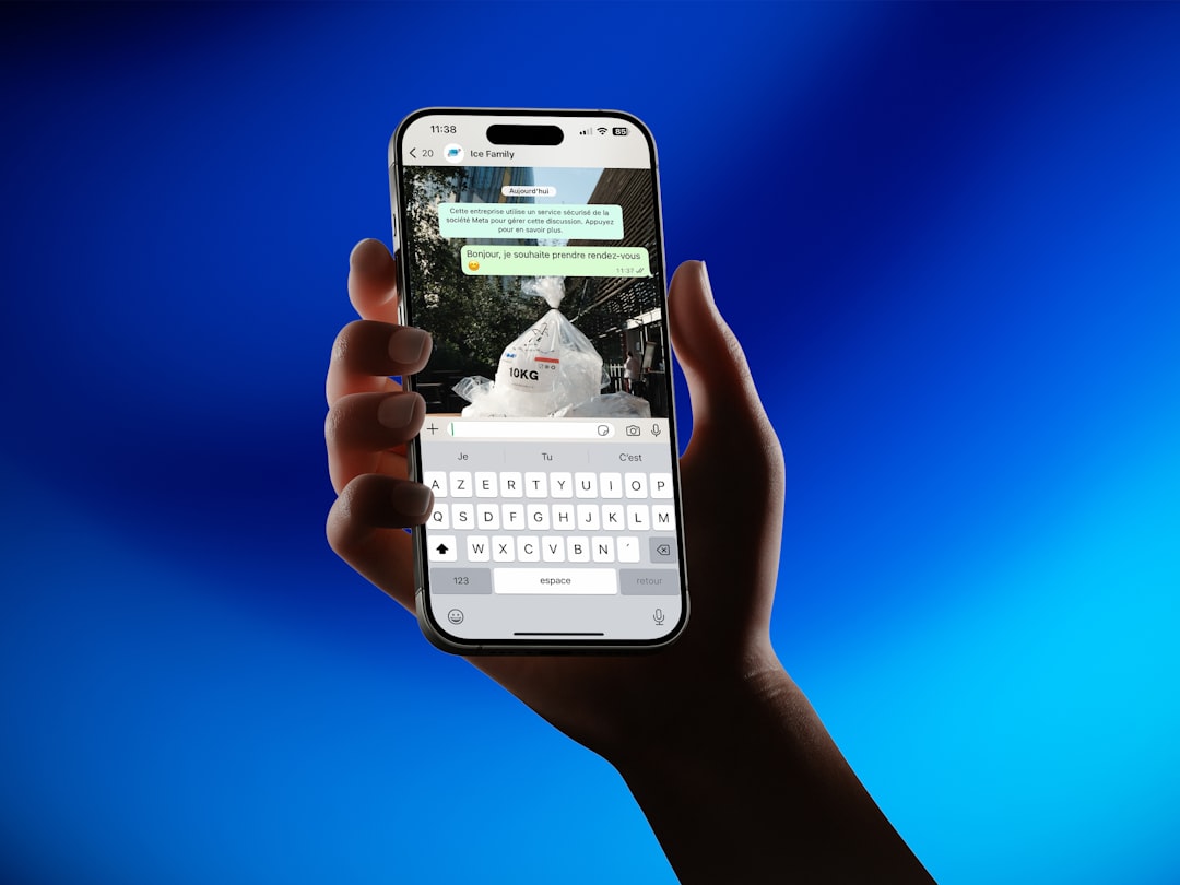 Hand holding smartphone showing messaging app whatsapp export chat screen mobile interface options