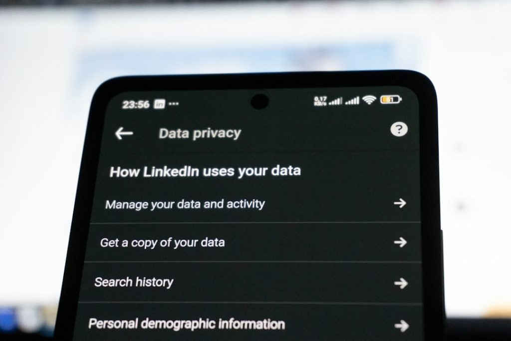 Linkedin data privacy settings on a smartphone screen personal data profile, address search, privacy risk