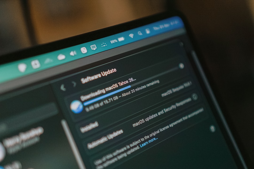 Macbook screen shows macos software update downloading laptop screen whatsapp web interface, chat window timestamps, desktop browser view