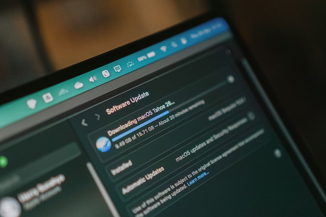 Macbook screen shows macos software update downloading laptop screen whatsapp web interface, chat window timestamps, desktop browser view