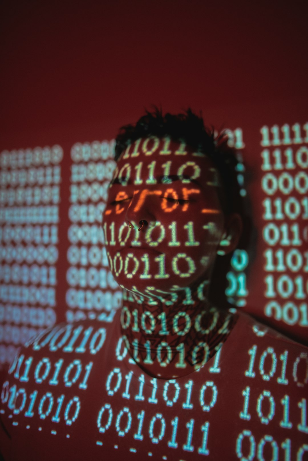 man in black and white checkered shirt cyber attack illustration, hacker at computer, red warning screen