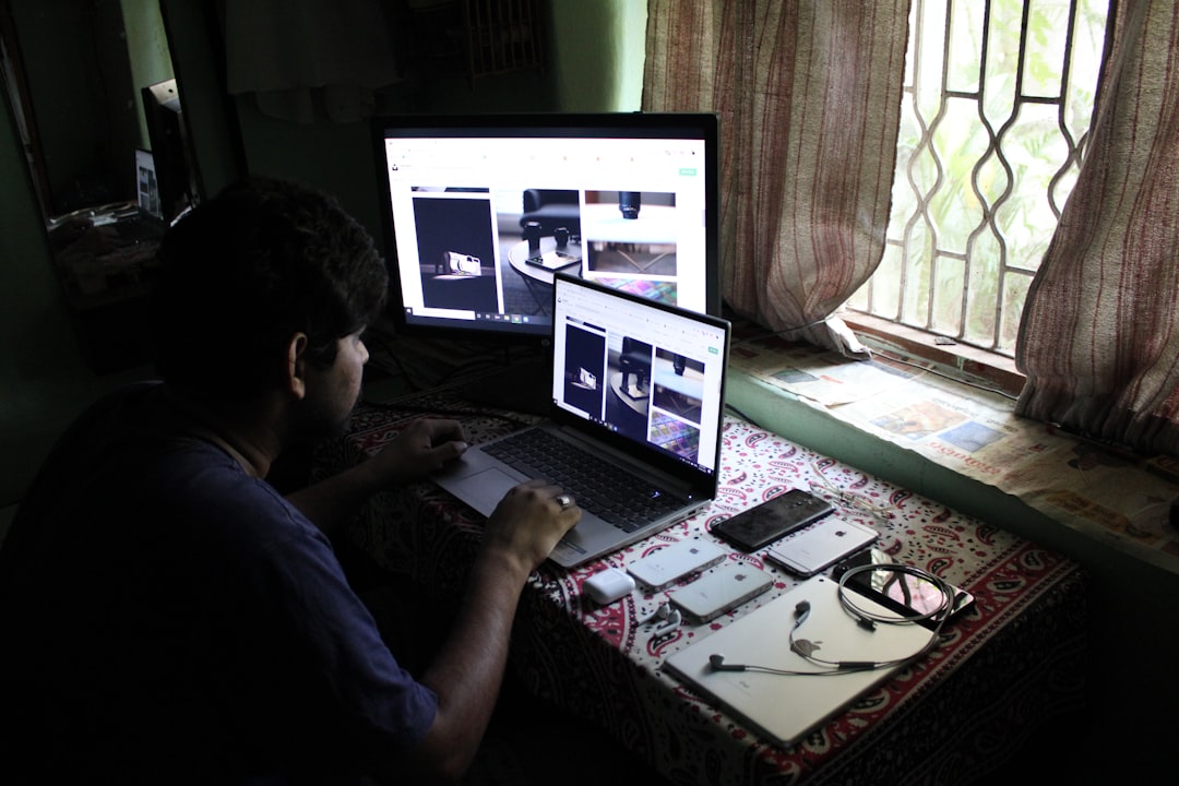 man in black shirt using laptop computer architect using 3D modeling software, house design model, digital blueprint on screen