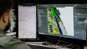 Man looking at circuit board design on computer screen. architect using 3D modeling software, house design model, digital blueprint on screen