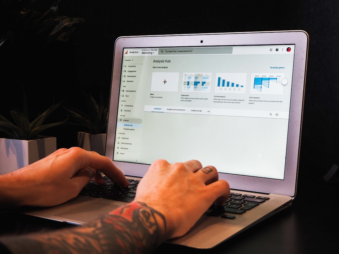 person using macbook pro on table data team, workshop session, laptop dashboards