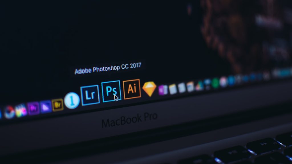 turned on MacBook Pro video editing dashboard multiple formats social media icons