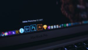 turned on MacBook Pro video editing dashboard multiple formats social media icons